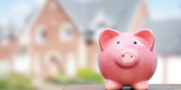 Saving to buy a house, real estate or home savings, piggy bank in front of property