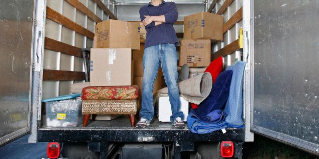 Young man standing inside moving van
