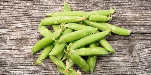 Fresh peas on a wooden background