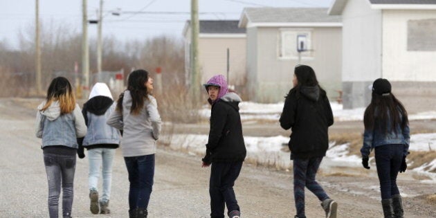 Girls walk on a street in the Attawapiskat First Nation in northern Ontario, Canada, April 14, 2016. REUTERS/Chris Wattie