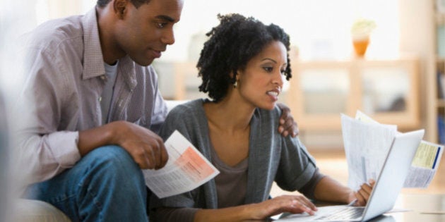 Couple paying bills using laptop