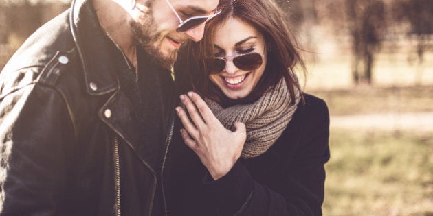 portrait of young beautiful stylish couple in autumn park