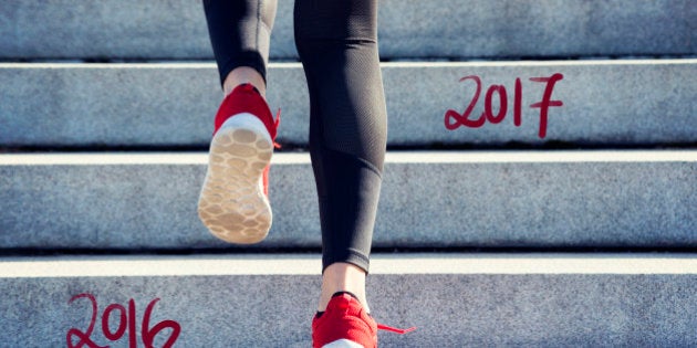 Female Runner jumping into the new Year 2017 and leaving 2016 behind.