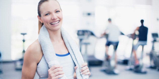 Portrait of smiling woman in gymnasium