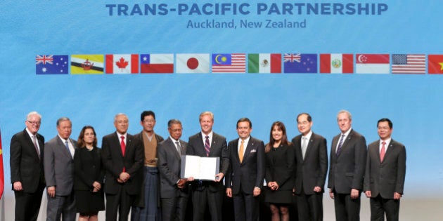 Trade delegates pose for a photograph after signing the Trans-Pacific Partnership Agreement in Auckland, New Zealand, Thursday, Feb. 4, 2016. Trade ministers from 12 Pacific Rim countries including the United States have ceremonially signed the free-trade deal. (David Rowland/SNPA via AP) NEW ZEALAND OUT