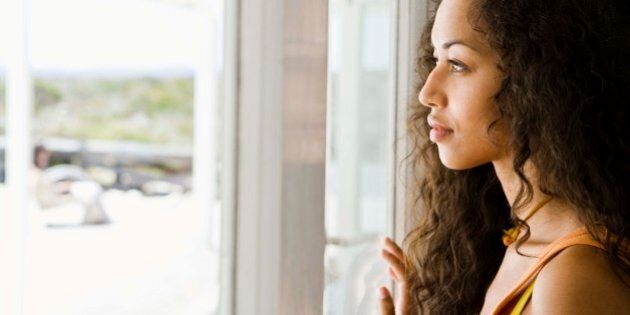 Woman daydreaming at window