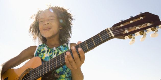 Young girl playing guitar