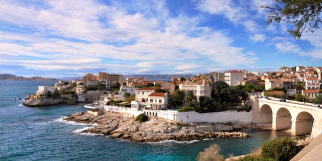 Small houses by sea and bridge.