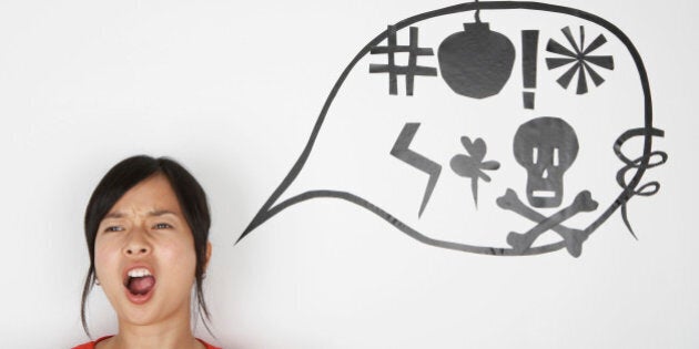 Woman shouting with speaking bubble signs on wall