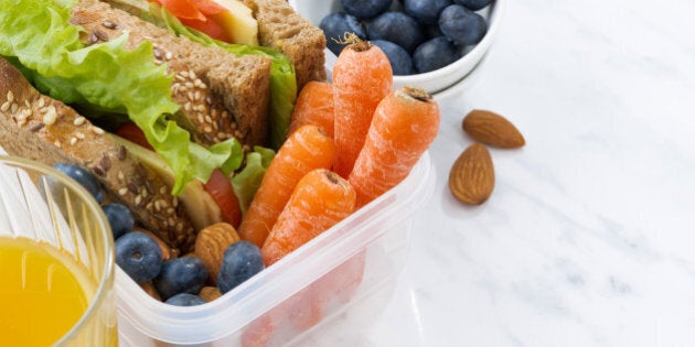 lunch box with sandwich of wholemeal bread on white background, closeup