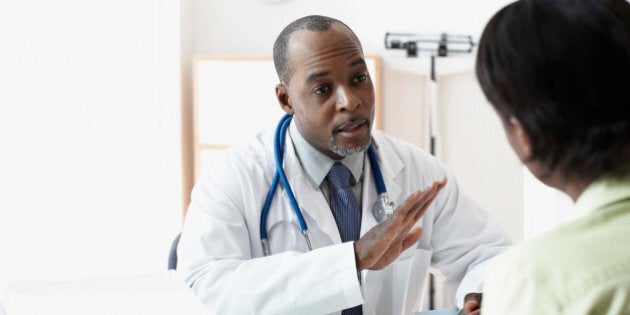 African male doctor talking to patient