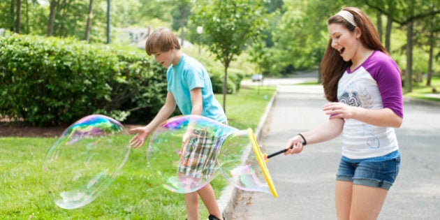 kids standing and playing on suburban street