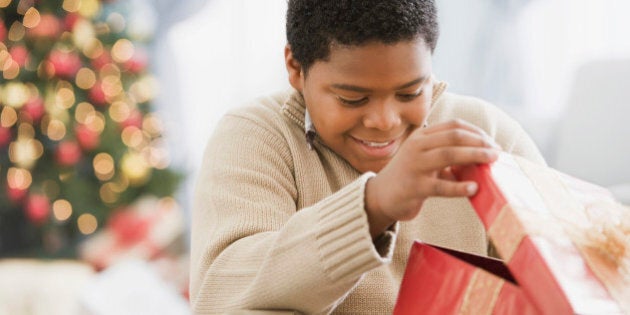 African boy opening gift