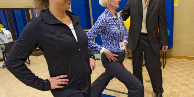 Dr. Bruce Crawford (far right), a urogynecologist from Nevada, watches while Jody Strik, manager of Work Fit Total Therapy Centre (far left) and Christina Daly, physiotherapist, demonstrate a lunging exercise. Dr. Crawford has developed do-at-home exercises to strengthen the pelvic floor known as pfilates. Pelvic floor disorders, such as incontinence, are common in women after childbirth and with aging and also in men with prostate problems. Pfilates is supposedly better than the current exercises, Kegels. June 8, 2012. (BERNARD WEIL/TORONTO STAR) DIGITAL IMAGE (Photo by Bernard Weil/Toronto Star via Getty Images)