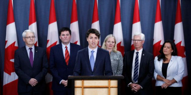 Canada's Prime Minister Justin Trudeau (3rd L) speaks during a news conference with Transport Minister Marc Garneau (L), Fisheries Minister Dominic LeBlanc (2nd L), Environment Minister Catherine McKenna (3rd R), Natural Resources Minister Jim Carr (2nd R) and Justice Minister Jody Wilson-Raybould in Ottawa, Ontario, Canada, November 29, 2016. REUTERS/Chris Wattie