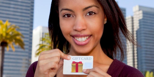 Woman smiling holding a gift card