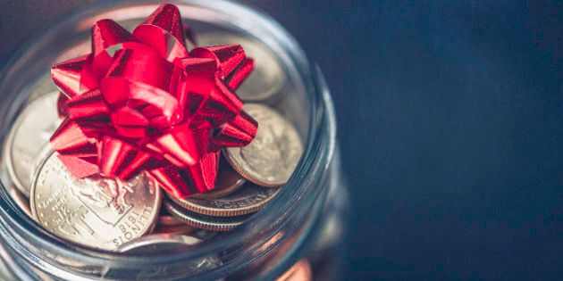 Christmas money jar with American currency and topped with bow