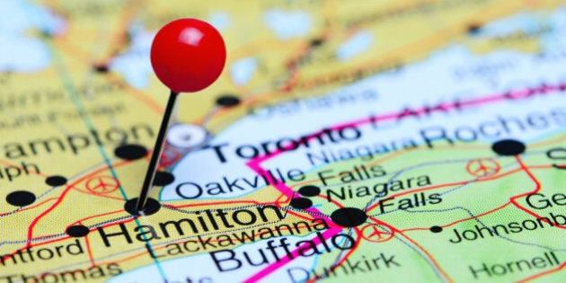 Photo of pinned Hamilton on a map of Canada. May be used as illustration for traveling theme.