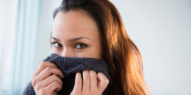 Woman wrapped in warm sweater