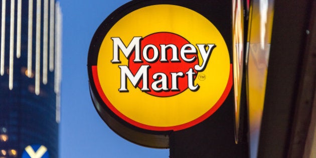 TORONTO, ONTARIO, CANADA - 2015/08/23: Signage of Money Mart hanging outside its store in Toronto. National Money Mart Company, commonly known as Money Mart, is a Canadian financial services company that provides payday loans, cheque cashing, tax preparation and money transfer services to the underbanked. (Photo by Roberto Machado Noa/LightRocket via Getty Images)