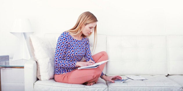 Woman doing bills on the sofa