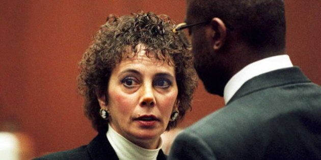 LOS ANGELES, CA - JANUARY 26: Lead prosecutor Marcia Clark (L) talks with fellow prosecutor Christopher Darden during court proceedings 26 January 1995 in Los Angeles. The O.J. Simpson trial was delayed by the hospitalization of prosecutor William Hodgman and continuing fray over the defense's failure to turn over the names of its anticipated witnesses. (COLOR KEY: Wall is brown.) AFP PHOTO (Photo credit should read POO/AFP/Getty Images)