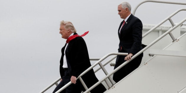 U.S. President-elect Donald Trump and Vice-President elect Mike Pence walk off Trump's plane upon their arrival in Indianapolis, Indiana, U.S., December 1, 2016. REUTERS/Mike Segar