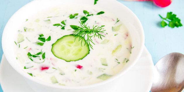 Cold soup with yogurt and vegetables and herbs close up