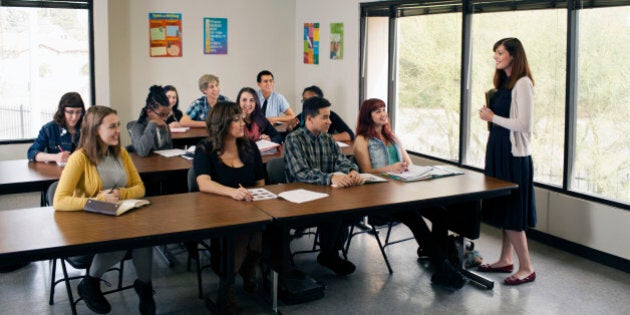 Female Instructor teaching high school class.