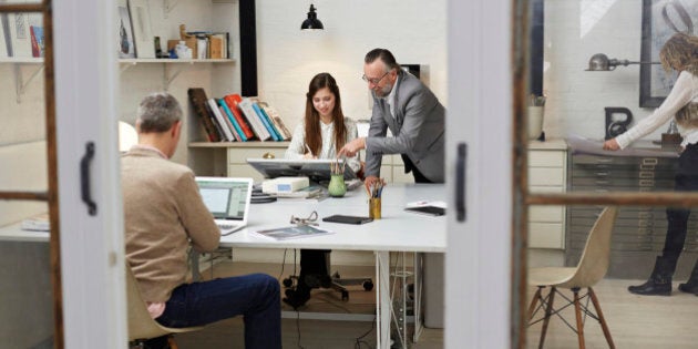 People working in small victorian style creative office