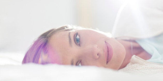 Close up of woman laying on bed