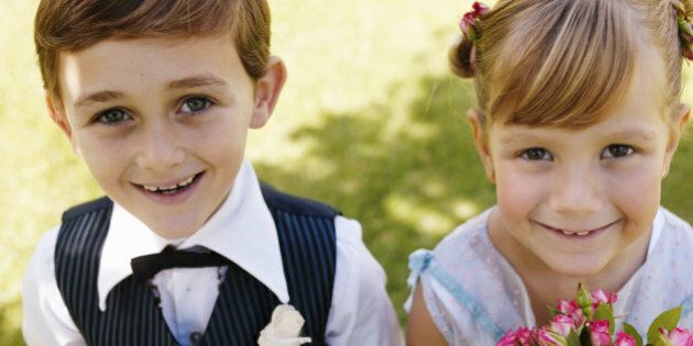 'Bridesmaid and pageboy(6-7) smiling, close-up, portrait'