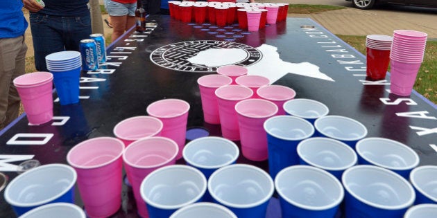 Courtney Edmonds, center, and her sister Melissa Edmonds, left, both of Arlington play beer pong before the game as the Houston Astros play the Texas Rangers at Globe Life Park on Friday, April 10, 2015 in Arlington, Texas. (Max Faulkner/Fort Worth Star-Telegram/TNS via Getty Images)