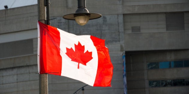 TORONTO, ONTARIO, CANADA - 2015/06/13: Canadian National flag waving in downtown Toronto.The National Flag of Canada, also known as the Maple Leaf and l'Unifolié . It is the first ever specified by statute law for use as the country's national flag. (Photo by Roberto Machado Noa/LightRocket via Getty Images)