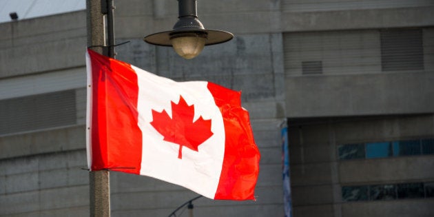 TORONTO, ONTARIO, CANADA - 2015/06/13: Canadian National flag waving in downtown Toronto.The National Flag of Canada, also known as the Maple Leaf and l'UnifoliÃ© . It is the first ever specified by statute law for use as the country's national flag. (Photo by Roberto Machado Noa/LightRocket via Getty Images)