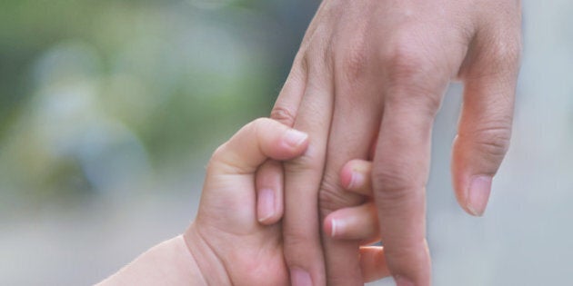 Mother and chilid holding hands, walk together.