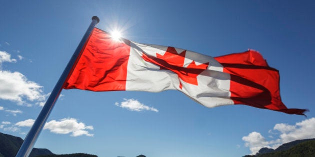 The Canadian Flag flies from the stern of the Uchuck 111 as it traverses Esperanza Inlet, British Columbia, Canada.