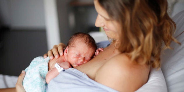 A newborn and his mother at maternity ward