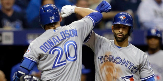 Toronto Blue Jays' Josh Donaldson (20) celebrates with on-deck batter Jose Bautista after hitting a home run off Tampa Bay Rays starting pitcher Drew Smyly during the fifth inning of a baseball game Monday, April 4, 2016, in St. Petersburg, Fla. (AP Photo/Chris O'Meara)