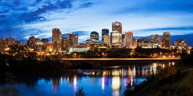 Panoramic view of Edmonton skyline reflected in North Saskatchewan River.