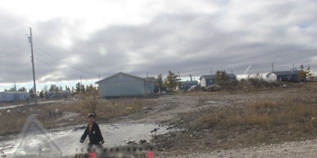 EASTERVILLE, MANITOBA - OCTOBER 21: A boy plays in an ice-covered puddle in Easterville, a First Nations reserve in northern Manitoba home to Shelly Lynn Chartier, the 29-year-old woman who allegedly impersonated and extorted NBA player Chris 'Birdman' Andersen as part of a complicated online con. October 21, 2013. (Brendan Kennedy/Toronto Star via Getty Images)