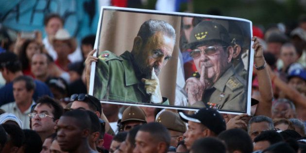 Attendees hold portraits of Cuba's late President Fidel Castro (L) and current President Raul Castro as they pay tribute to Fidel Castro at a massive rally at Revolution Square in Havana, Cuba, November 29, 2016. REUTERS/Carlos Garcia Rawlins