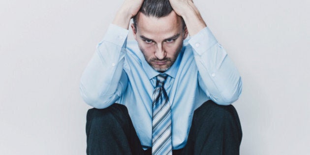 Portrait of an exhausted business man in studio.