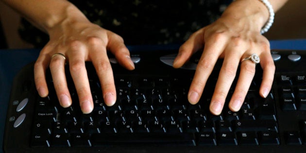 Bojana Danilovic, 29, types on her keyboard upside down in the southwestern Serbian town of Uzice August 22, 2013. Danilovic suffers from a rare brain condition called spatial orientation phenomenon, which has left her reading books and newspapers, and typing and writing, upside down because her brain does not process images normally. While her eyes see the world the right way up, her brain flips the image over. Danilovic says she is unique in suffering from the condition in such a way. Picture taken August 22, 2013. REUTERS/Marko Djurica (SERBIA - Tags: SOCIETY)