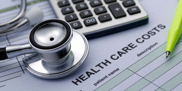 Health care Cost statistics with stethoscope and Calculator