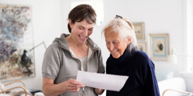 Two generations women reading document together