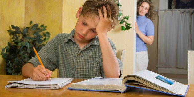 Mom looking at son frustrated with homework