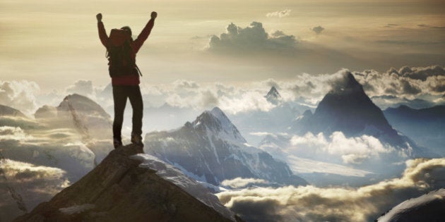 Climber standing on a mountain summit