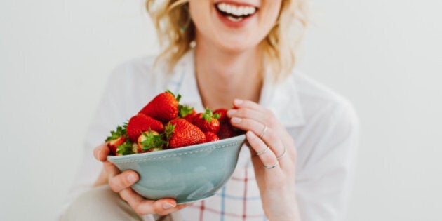 Young woman eating strawberries