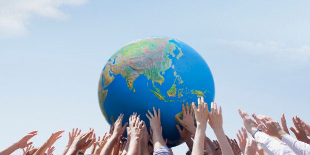 Crowd reaching for globe